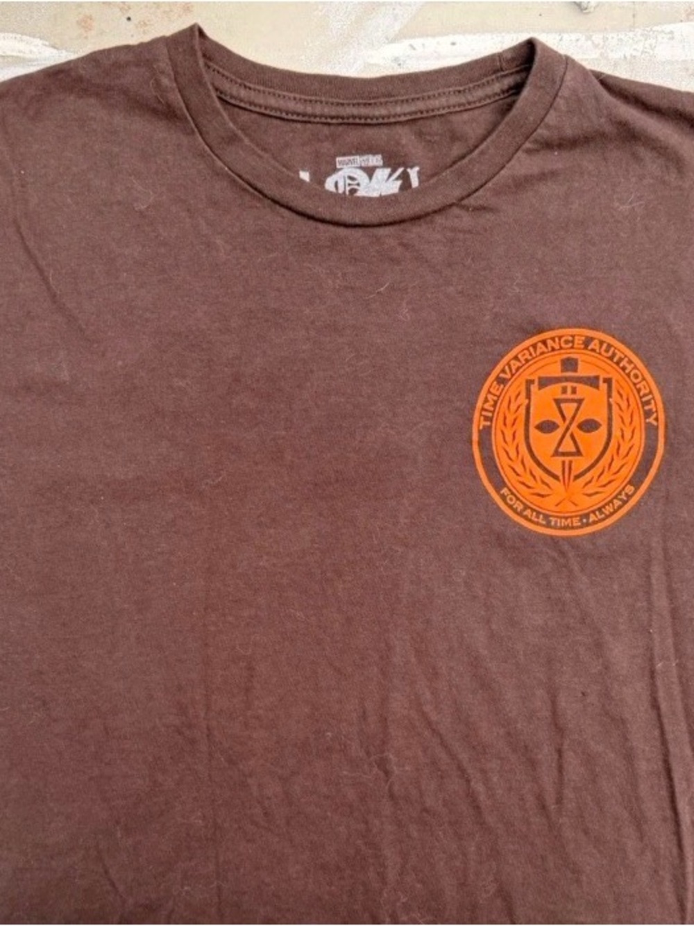 Marvel Brown Short Sleeve Tee with Orange Time Variance Authority Emblem